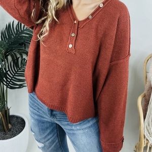 Long Sleeve knit sweater,  non functional buttons.Size Large.  White Birch Brand